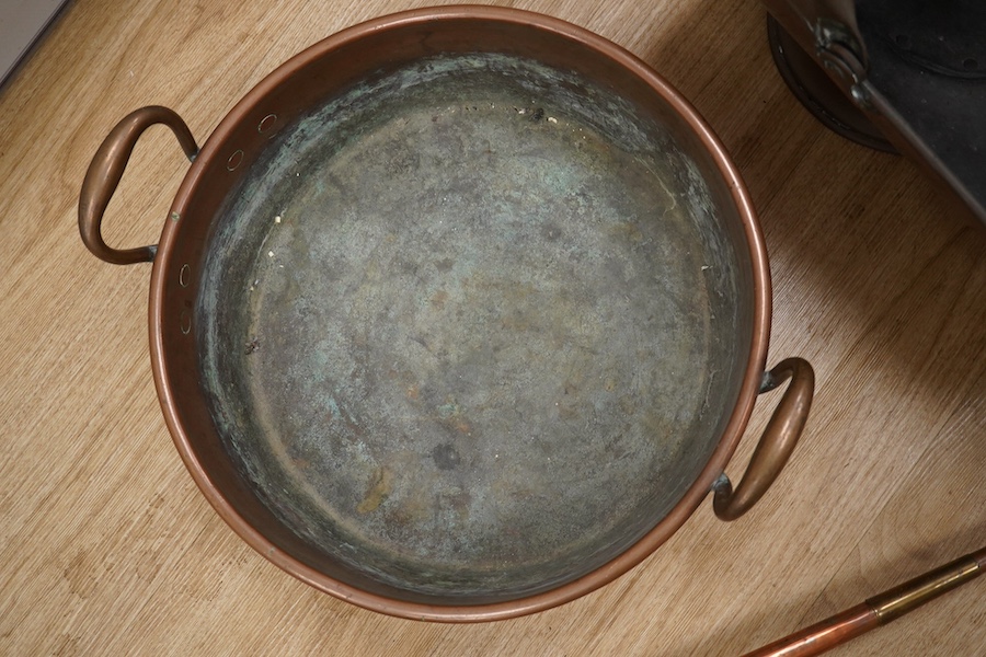 Victorian copper, including a two handled preserve pan, a copper hunting horn, a helmet coal scuttle and a warming pan. Scuttle 32cm high. Condition - hunting horn dented